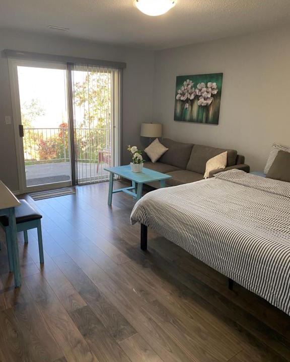 Kamloops House | Guest suite with patio that backs onto greenbelt