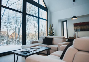 Large windowed chalet surrounded by nature