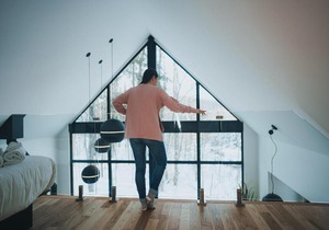 Large windowed chalet surrounded by nature