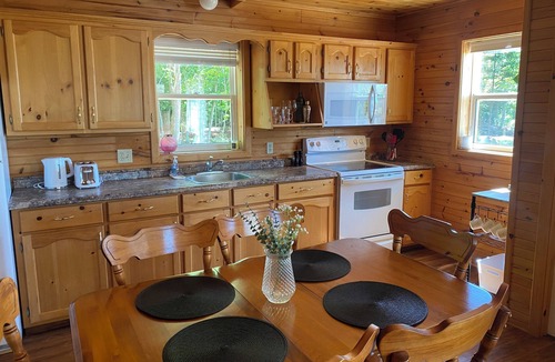 Borden-Carleton Cottage | Cozy cabin style cottage tucked into the woods with a view of the water.
