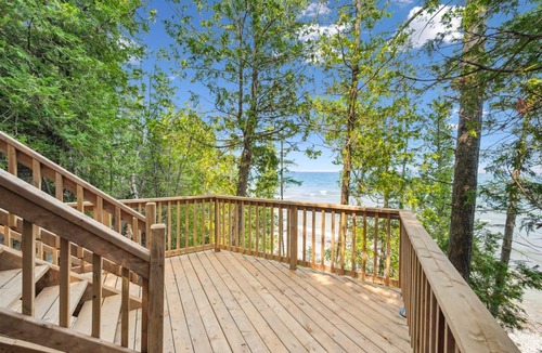 Lion's Head Cabin | Disconnect from it all at Stonewood, a cozy log chalet nestled in cedar forest on Georgian Bay. Enjoy a private shoreline, wraparound deck, wood stove, and access to kayaks, and trails. Peace, comfort, and adventure await in Cape Chin South.