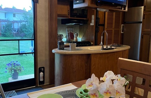 Leduc County House | Flex RV Travel trailer parked on a beautiful 4 acre lot, overseeing forest land.