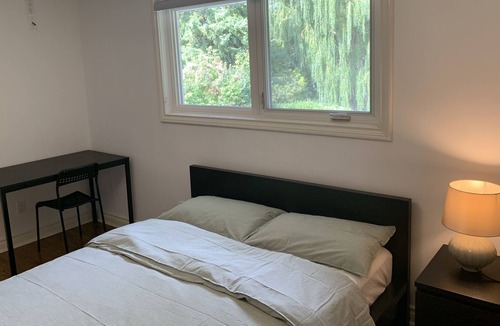 Rathwood Villa | Master bedroom with picturesque view to backyard and ravine