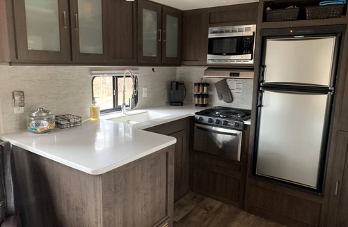 Clare House | Modern RV camper with all the perks nNestled in tree at lake edge