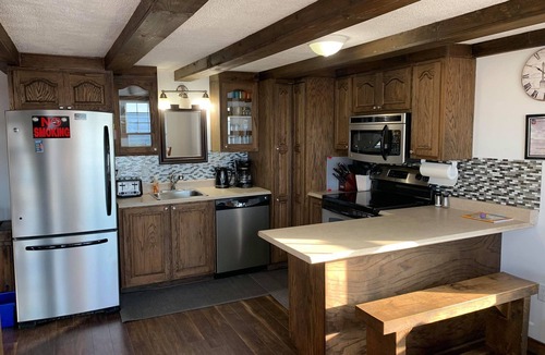 Trout River House | Ocean Breeze offers modern amenities in a renovated saltbox house.