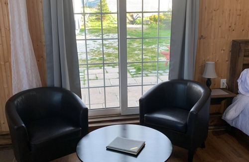 Trout River House | Ocean Breeze offers modern amenities in a renovated saltbox house.