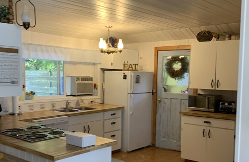 Christina Lake Cottage | Quaint Lakefront cottage that sleeps 10. Deck, hot tub and large fenced yard.