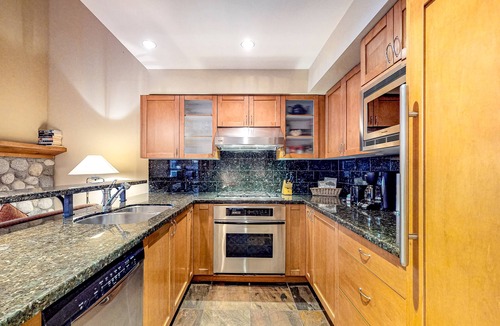 Village North House | Relaxing first-floor townhouse with a private hot tub, fireplace, & great views