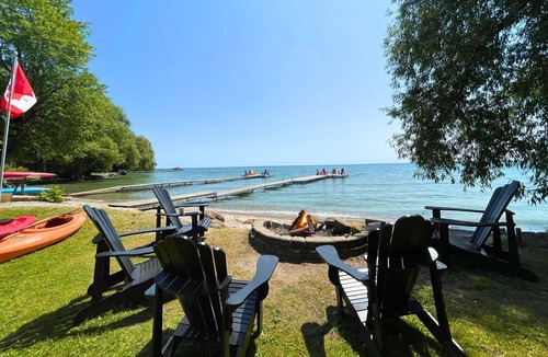 Big Bay Point Cottage | Shallow Beach Lakefront Cottage perfect with Kayak, Firepit, BBQ + Playground