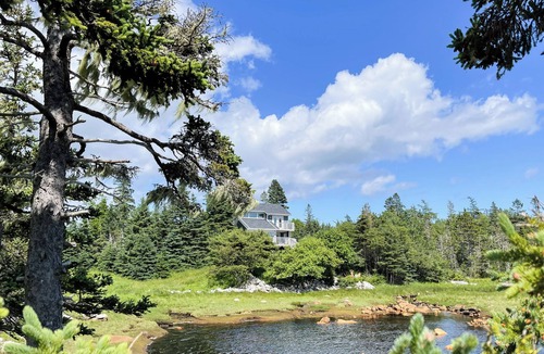 East River Point House | The oceanside Hideaway is nestled between the trees with stunning ocean views