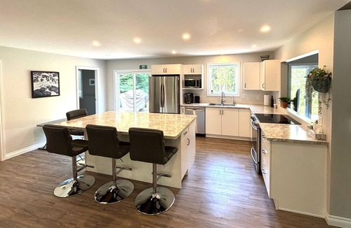 Lion's Head Cabin | This bright and spacious retreat blends modern comfort with cozy cottage charm. Featuring a fully equipped kitchen, multiple cozy bedrooms, stylish bathrooms, and inviting living spaces with a wood-burning fireplace.