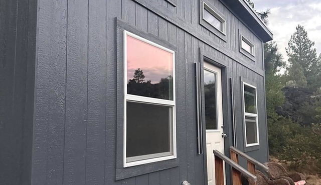 Adorable tiny home cozied up to lava rock!
