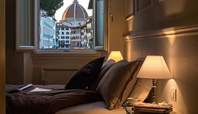 Deluxe suite with great view! Bed and view in the heart of Florence.