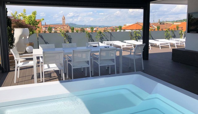 Exclusive penthouse in the historic center of Alba, panoramic terrace with garden and private pool and solarium.